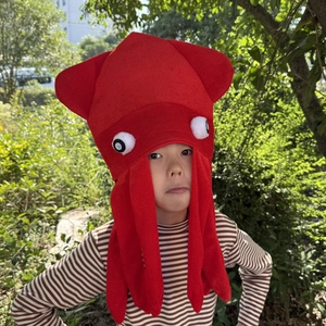 Detailed view of a soft red plush octopus hat with cartoon eyes for kids' party fun