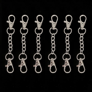 Set of six silver alloy lobster clasp keychains with chain links on black background