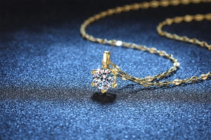 Macro detail of a 1-carat moissanite pendant with six-prong setting on a gold chain