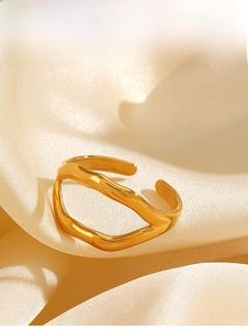 Detail showing wavy texture and hollow design on a gold-plated adjustable ring
