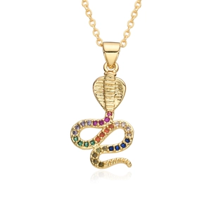 Macro shot of gold-plated cobra pendant set with colorful stones on white background