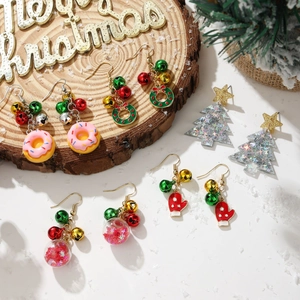 Flat lay detail of assorted Christmas earrings including Santa gloves and wreaths