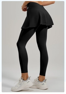 Detail view of high-waist black 2-in-1 tennis skirt leggings with compression fabric