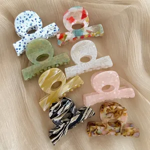 Eight-piece set of elegant acetate hair clips in assorted marble and tortoise patterns