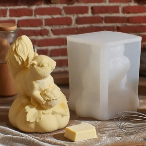 Detail of white silicone squirrel mold and finished resin art on a warm rustic kitchen background