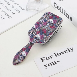 Colorful sugar skull and rose pattern anti-static massage hairbrush in a lifestyle setting