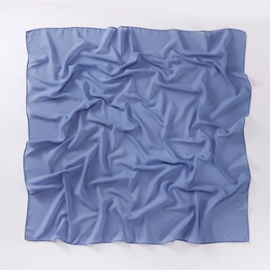 Detail shot of blue square chiffon scarf showing lightweight fabric and soft texture