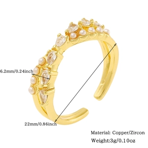 Detail of adjustable gold ring featuring alternating pearls and marquise cut zircons