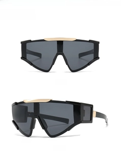 Front and side view of oversized black wrap sunglasses with gold top metal bar detail