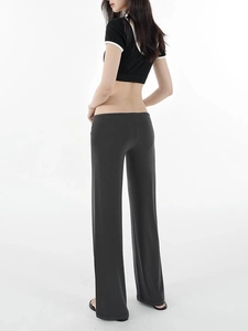 Rear view of black crop top and matching low-rise wide-leg trousers on a model
