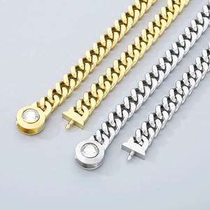 Detailed view of 11mm Cuban link chains in gold and silver with crystal skulls and box clasps