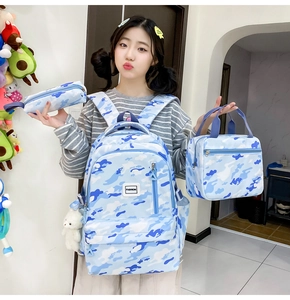 Blue camouflage backpack set including lunch bag and pencil case worn by a student