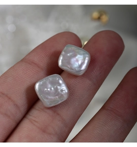 Macro close-up showing the natural iridescent luster and square shape of baroque pearls