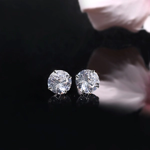Elegant S925 sterling silver stud earrings with four-claw round zircon in dark background