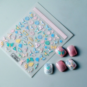 Macro view of 5D embossed butterfly nail art stickers with intricate floral lace details