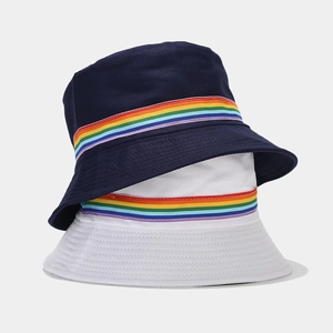 Reversible bucket hats in navy and white featuring colorful rainbow ribbon detailing