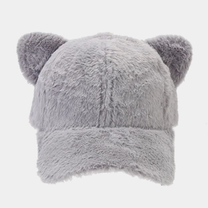 Close-up of soft grey plush baseball cap featuring cute decorative cat ears texture