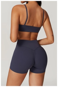 Detail of high-waisted yoga shorts with V-shaped scrunch bum design in dark grey blue