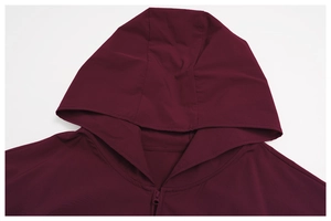 Detail of burgundy windproof hooded jacket showing zipper closure and fabric texture