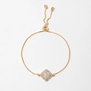 Detail of adjustable gold-plated box chain bracelet with sparkling rhombus zircon pendant