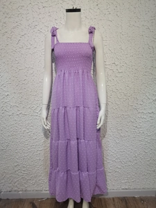 Detail of purple swiss dot dress showing tiered skirt layers and tie-up shoulder straps