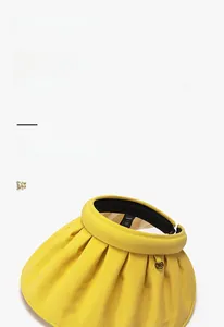 Detail of yellow sun hat with black glue coating and wide brim for UV protection