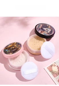 Detail of loose setting powder with cute animal lids and soft puffs on pink background