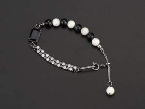 Macro shot of a hip-hop bracelet with natural stones and pavé set crystals on silver metal