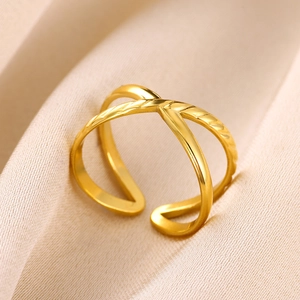 Dettaglio macro dell'anello a doppia croce placcato oro 18K su seta color champagne