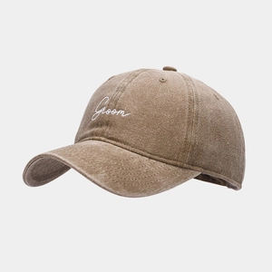 Close-up of Groom embroidery on washed brown cotton vintage style baseball cap