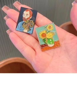 Detail of Van Gogh art enamel pins showing sunflower and self-portrait oil painting designs