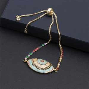 Close-up of golden evil eye bracelet with colorful zircons on a luxury jewelry box