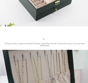 Detail of green leather jewelry box with necklace hooks and velvet storage compartments