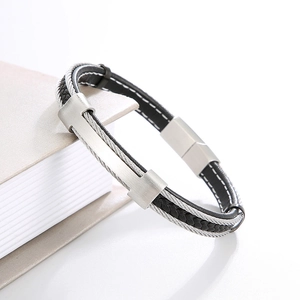 Detail of men's black braided leather bracelet with silver brushed metal magnetic clasp