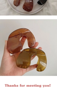 Macro view of large vintage amber and dark green hair claws in plastic material