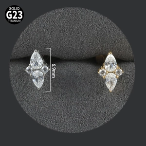 Macro detail of G23 titanium marquise zircon stud showing 6.9mm height and material stamp