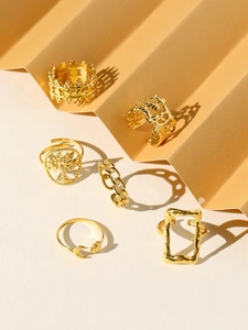 Detail of 18k gold-plated ring set featuring Tree of Life and geometric textured designs