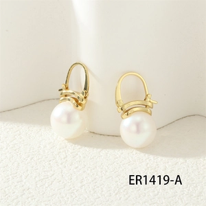 Detail of 18K gold plated pearl earrings with twisted metal lines and zircon inlay