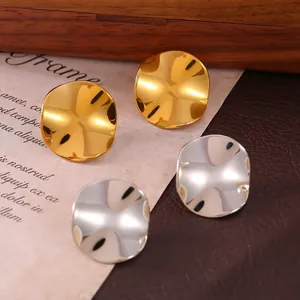 Textured gold and silver irregular pleated stud earrings in a vintage setting
