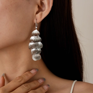 Silver tiered metal leaf petal tassel earrings shown on model for elegant style