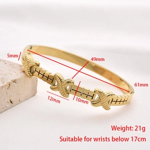Macro detail of golden stainless steel bangle with X-shaped cross elements and 5mm width