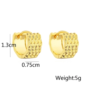 Detail view of 18k gold plated huggie earrings with diamond cut texture, 1.3cm in height