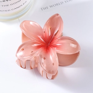 Detail of pink translucent resin flower hair claw clip with smooth jelly finish texture
