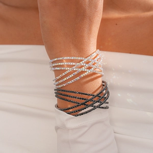 Close-up of three-layer criss-cross bracelet set with sparkling crystal rhinestones