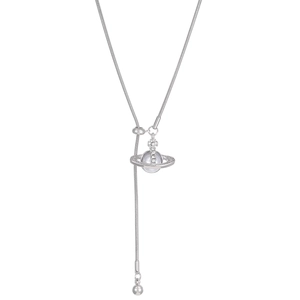 Detail of silver snake bone Y-necklace featuring a crystal-set planet charm and ball drop