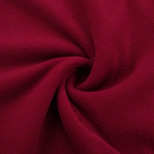 Macro shot of soft burgundy fleece fabric texture on a slim-fit shoulder dress