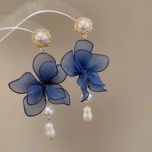 Detail of blue organza flower earrings with baroque pearls and gold-plated accents