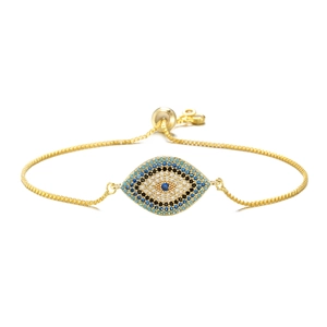 Detail of adjustable evil eye bracelet with blue and white cubic zirconia in gold plating