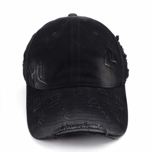 Close-up of distressed vintage baseball cap with frayed holes and worn-out fabric details