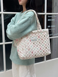 Detail of quilted cotton tote bag featuring cute pink bear print and floral patterns